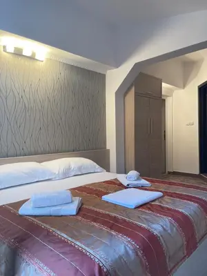 a large bed with two towels on top of it at Monte Perla Residence in Sveti Stefan
