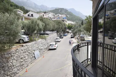 a view from a balcony of a street with cars parked at Monte Perla Residence in Sveti Stefan