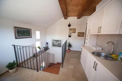 a kitchen with a sink and a staircase in a room at Vida`s house in Virpazar