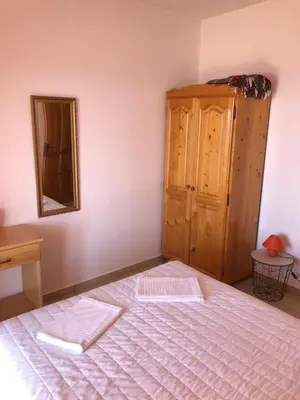 a bedroom with a bed and a mirror and a dresser at Apartments Djulija in Sutomore