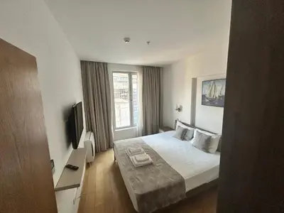 a hotel room with a bed and a television at Apartments Krug in Budva