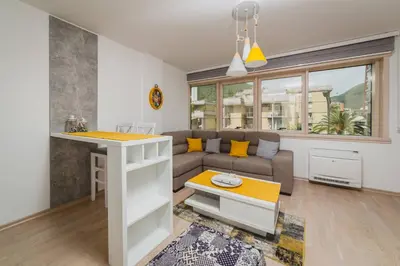 a living room with a couch and a table at Apartments Krug in Budva
