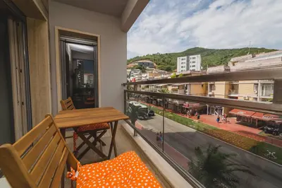 a balcony with a table and a view of a city at Apartments Krug in Budva