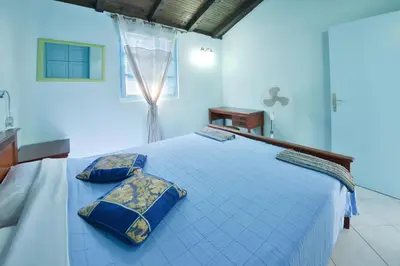 a blue bedroom with a large bed with two pillows at Kazanegra Exclusive Apartments in Sveti Stefan
