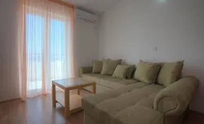 a living room with a couch and a table at Apartments Đurašević in Sveti Stefan