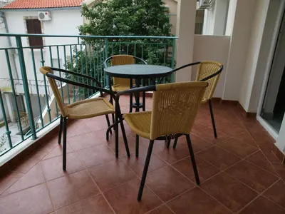 a table and chairs sitting on a balcony at Apartments Obala B&B - Dragović in Petrovac na Moru
