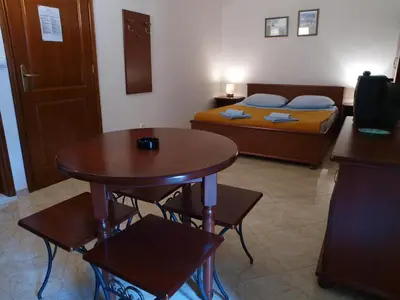 a small room with a table and a bed at Apartments Obala B&B - Dragović in Petrovac na Moru