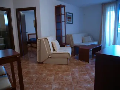 a living room with two chairs and a couch at Apartments Laništa - Dragović in Petrovac na Moru