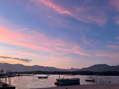 a group of boats in the water at sunset at Apartments Kovinic in Tivat