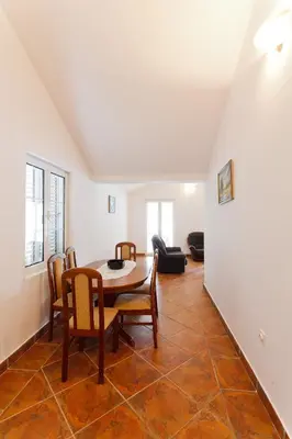 a dining room with a table and chairs at Apartments Kovinic in Tivat