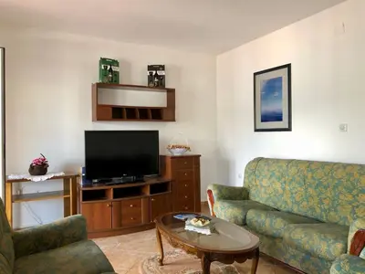 a living room with a couch and a flat screen tv at Apartments Kovinic in Tivat