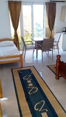 a bedroom with a bed and a table and chairs at Cozy studio by the sea in Ulcinj, 35 m² with view in Ulcinj