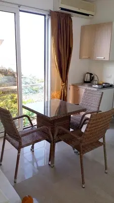 a table and two chairs in a kitchen with a table at Cozy studio by the sea in Ulcinj, 35 m² with view in Ulcinj