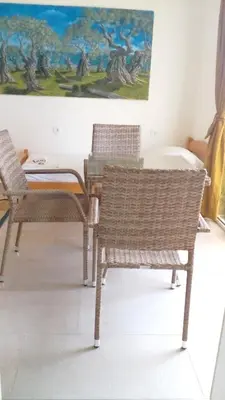 two chairs and a table in a room with a painting at Cozy studio by the sea in Ulcinj, 35 m² with view in Ulcinj