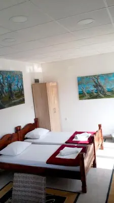two beds in a room with two posters on the wall at Cozy studio by the sea in Ulcinj, 35 m² with view in Ulcinj