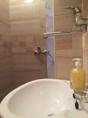 a bathroom sink with a bottle of soap on it at Apartments Aleksic in Sutomore