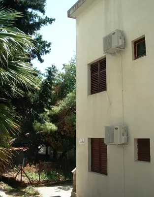 a building with windows and air conditioners on it at Apartments Aleksic in Sutomore