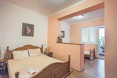 a bedroom with a bed and a window at David apartments and rooms in Dobra Voda