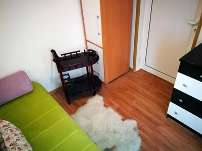 a living room with a green couch and a table at Apartment White Lily of Budva in Budva