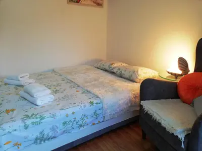 a bedroom with a bed with towels on it at Apartment White Lily of Budva in Budva