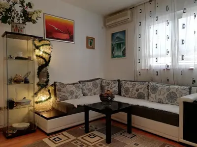 a living room with a couch and a table at Apartment White Lily of Budva in Budva