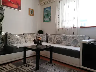 a living room with a couch and a table at Apartment White Lily of Budva in Budva