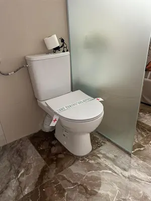 a bathroom with a toilet with a sign on it at House Pravilovic apartments in Cetinje