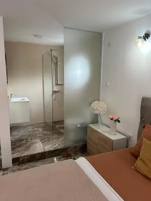 a bedroom with a shower and a bed at House Pravilovic apartments in Cetinje