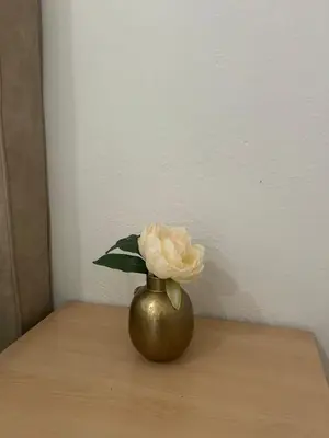 a vase with a flower in it on a table at House Pravilovic apartments in Cetinje