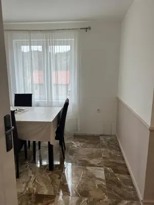 a dining room with a table and a window at House Pravilovic apartments in Cetinje