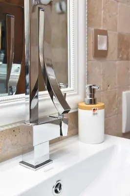 a bathroom sink with a chrome faucet and a mirror at Old Town Skyline apartment 3 in Budva