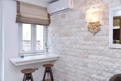 a room with two stools and a brick wall at Old Town Skyline apartment 3 in Budva