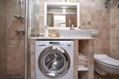 a bathroom with a washing machine and a sink at Old Town Skyline apartment 3 in Budva