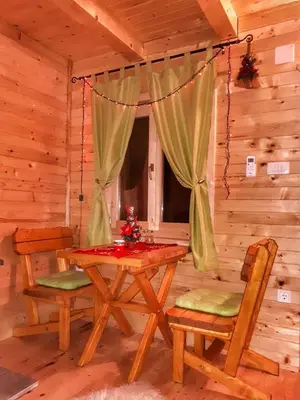a dining room with a table and chairs in a cabin at Brvnara Borovik in Cetinje