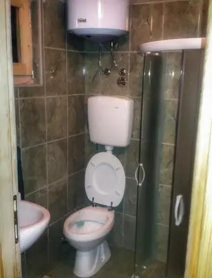 a small bathroom with a toilet and a sink at Brvnara Borovik in Cetinje