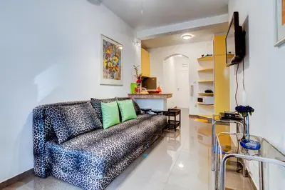 a living room with a couch and a table at Sun Rose Apartments Sveti Stefan in Sveti Stefan