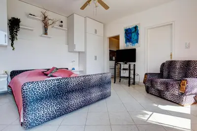a living room with two couches and a television at Sun Rose Apartments Sveti Stefan in Sveti Stefan