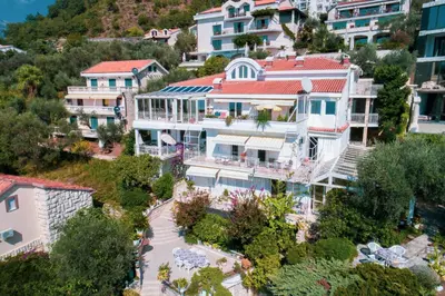 an aerial view of a building in a city at Sun Rose Apartments Sveti Stefan in Sveti Stefan