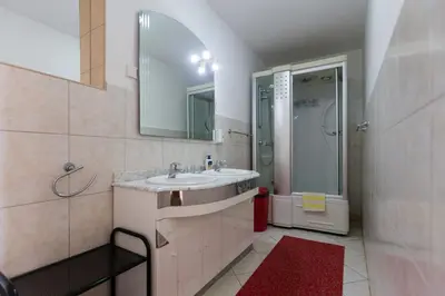 a bathroom with a sink and a shower at Sun Rose Apartments Sveti Stefan in Sveti Stefan
