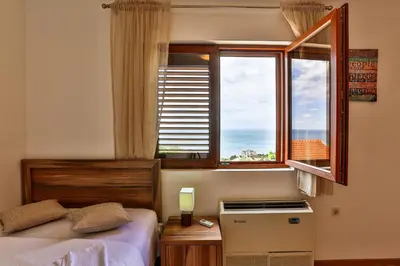 a bedroom with a bed and a window at Villa Rijeka Rezevici in Petrovac na Moru