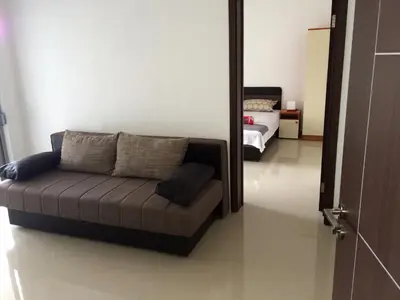 a couch sitting in a room with a bedroom at Apartments Perezaj II in Ulcinj
