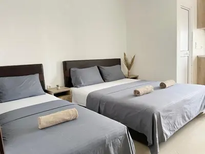 a bedroom with two beds with towels on them at Apartments Perezaj II in Ulcinj