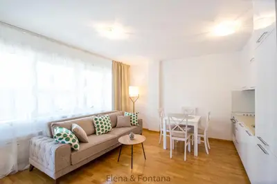 a living room with a couch and a table at Elena&Fontana Apartment in Budva