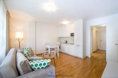 a living room with a couch and a table at Elena&Fontana Apartment in Budva