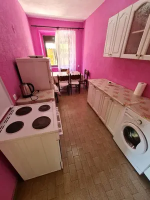 a kitchen with a stove and a washing machine at Apartment Dragone in Ulcinj