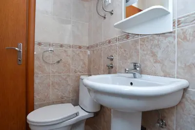 a bathroom with a white sink and a toilet at Apartments Mara in Budva