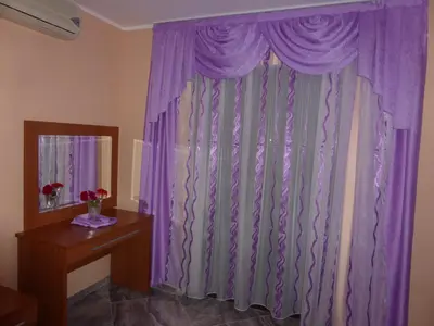 a purple curtain in a room with a table at Apartments Mara in Budva