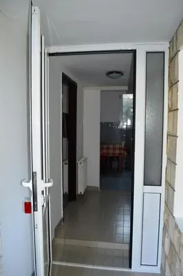 an open door to a hallway with a table at Guest House Ratko in Rafailovici