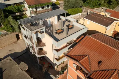 an overhead view of a white house with red roofs at Guesthouse Marko in Becici
