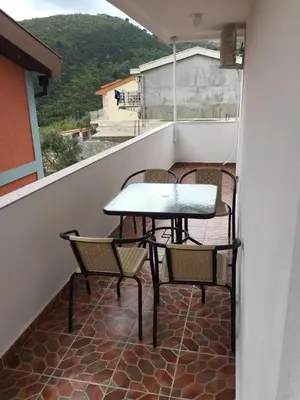 a table and chairs on a balcony with a view at Guesthouse Marko in Becici